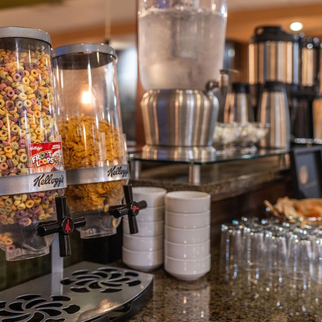 A breakfast bar with Kellogg's Frost Loops cereal and a coffee machine.