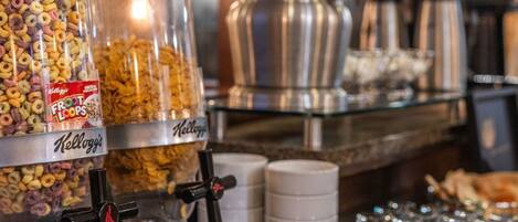 A breakfast bar with Kellogg's Frost Loops cereal and a coffee machine.