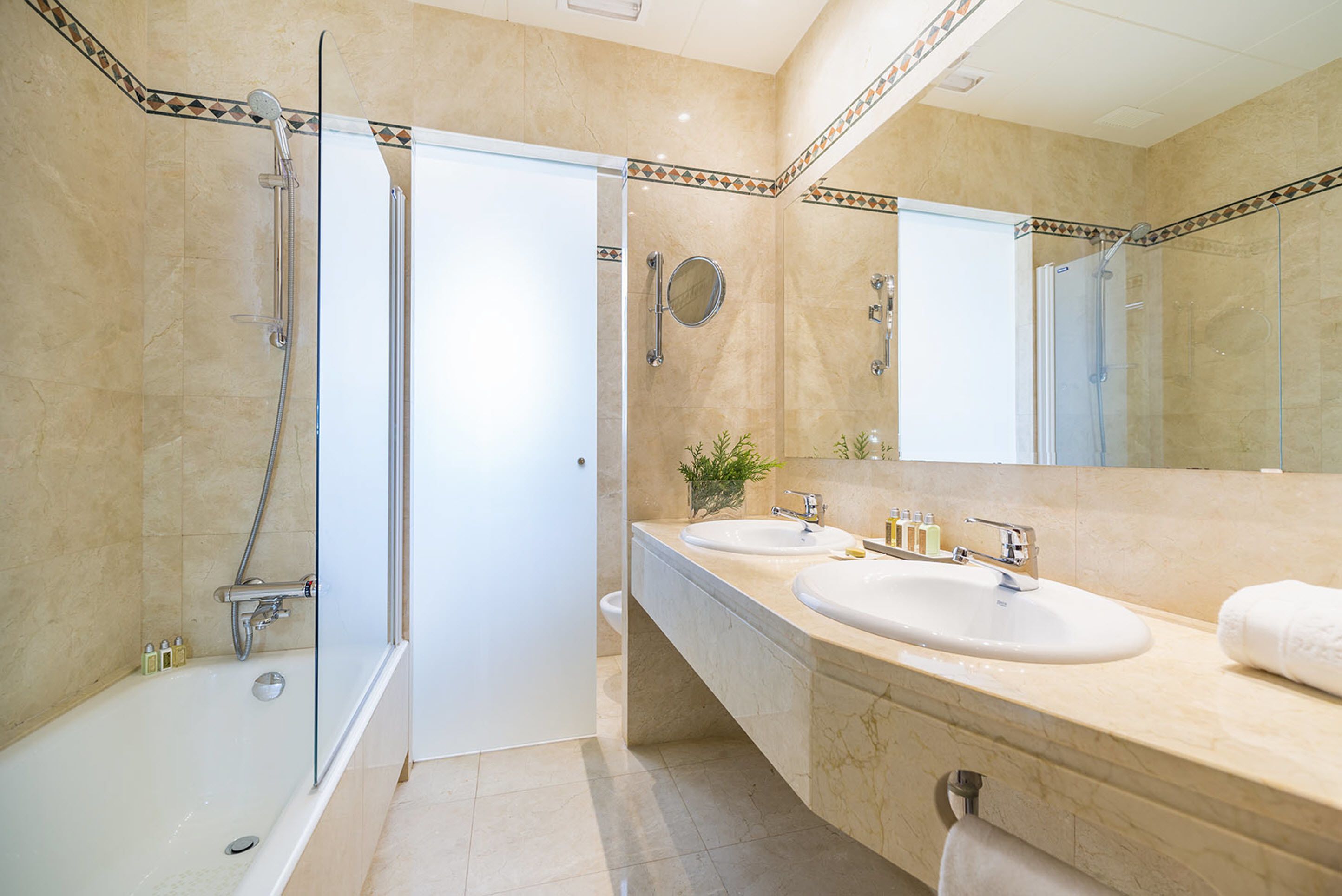 combined shower/bathtub, designer toiletries, hair dryer, slippers