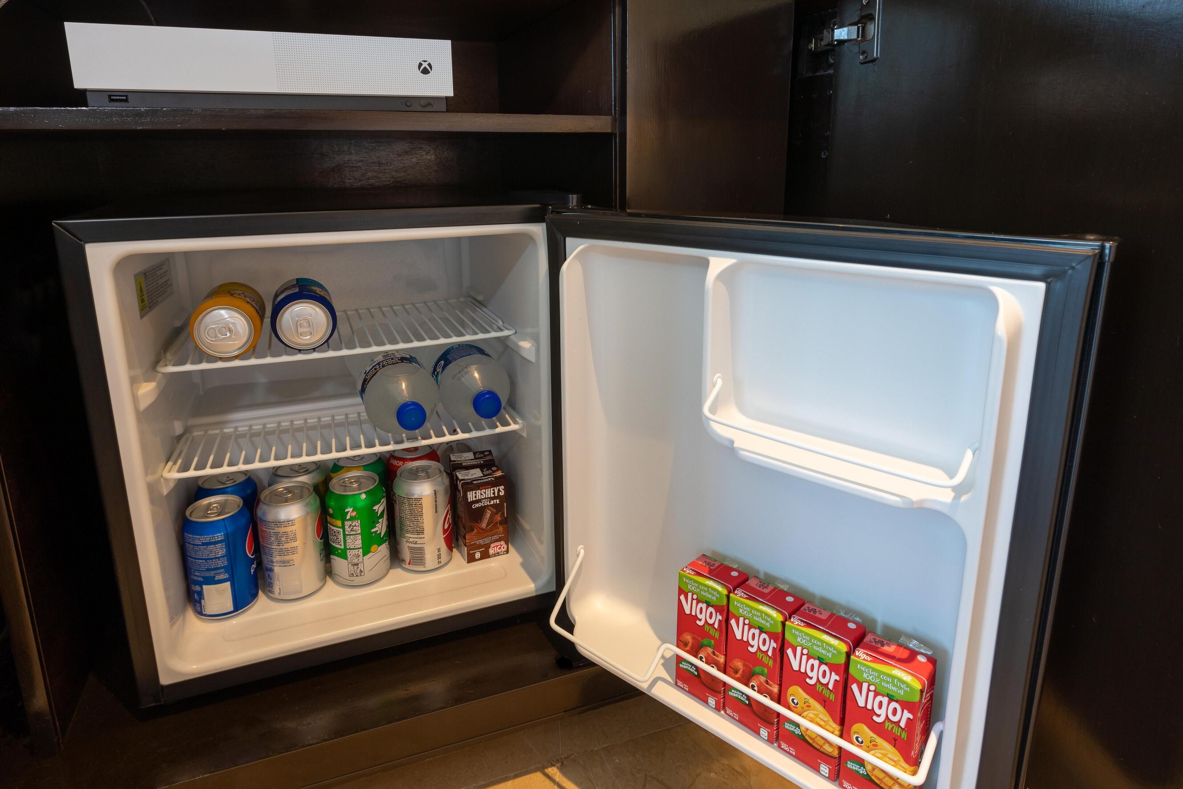 An open refrigerator with various beverages and snacks.