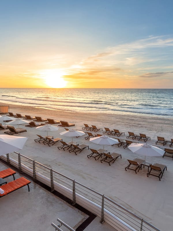 On the beach, white sand, sun loungers, beach umbrellas