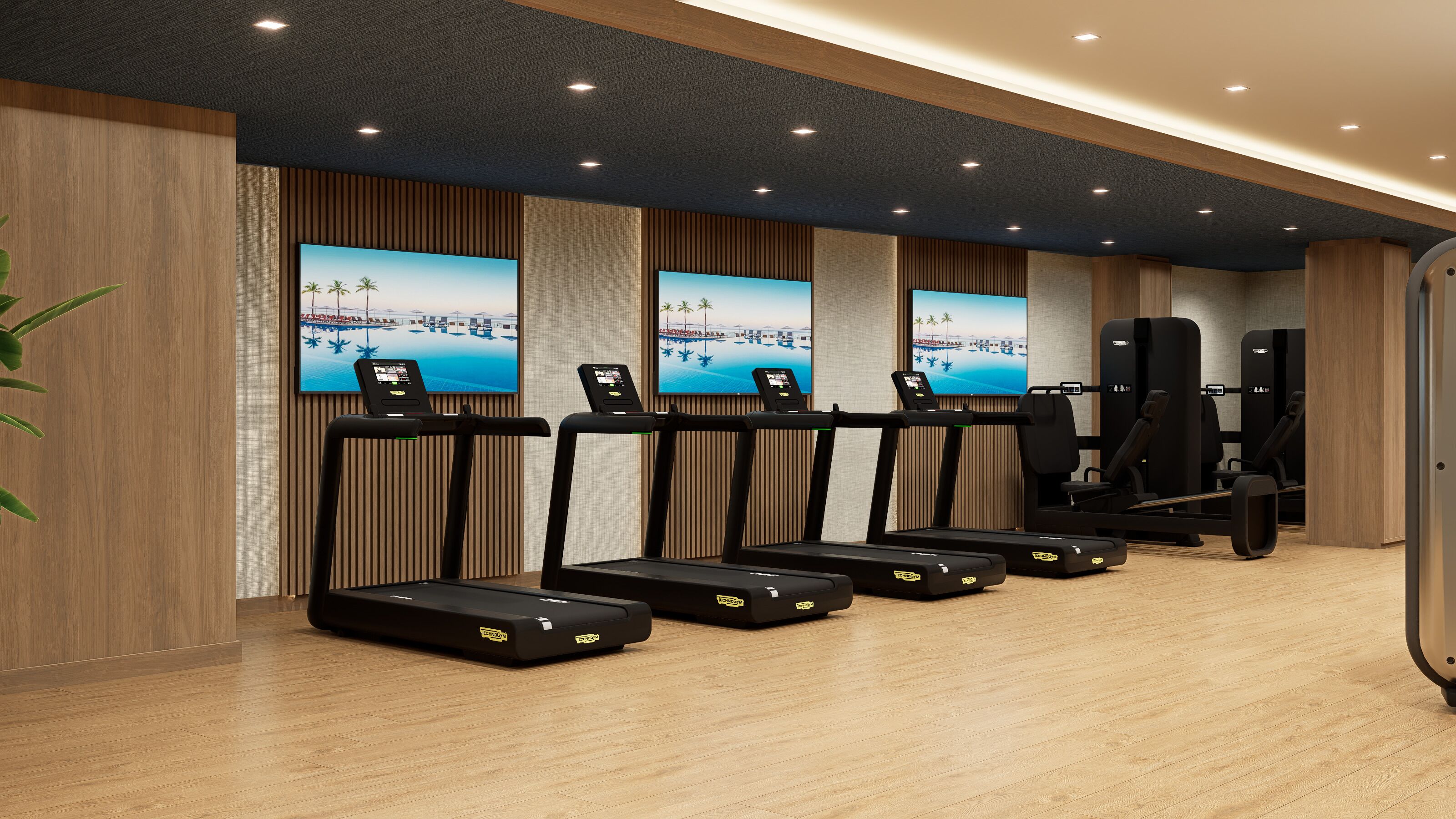 A modern gym with treadmills, exercise bikes, and a large screen displaying a tropical resort.