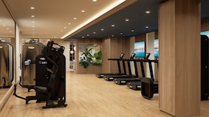 A modern gym with cardio machines, a mirror, and wooden walls.