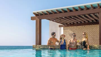 A pool area with a wooden pergola and a patterned wall.