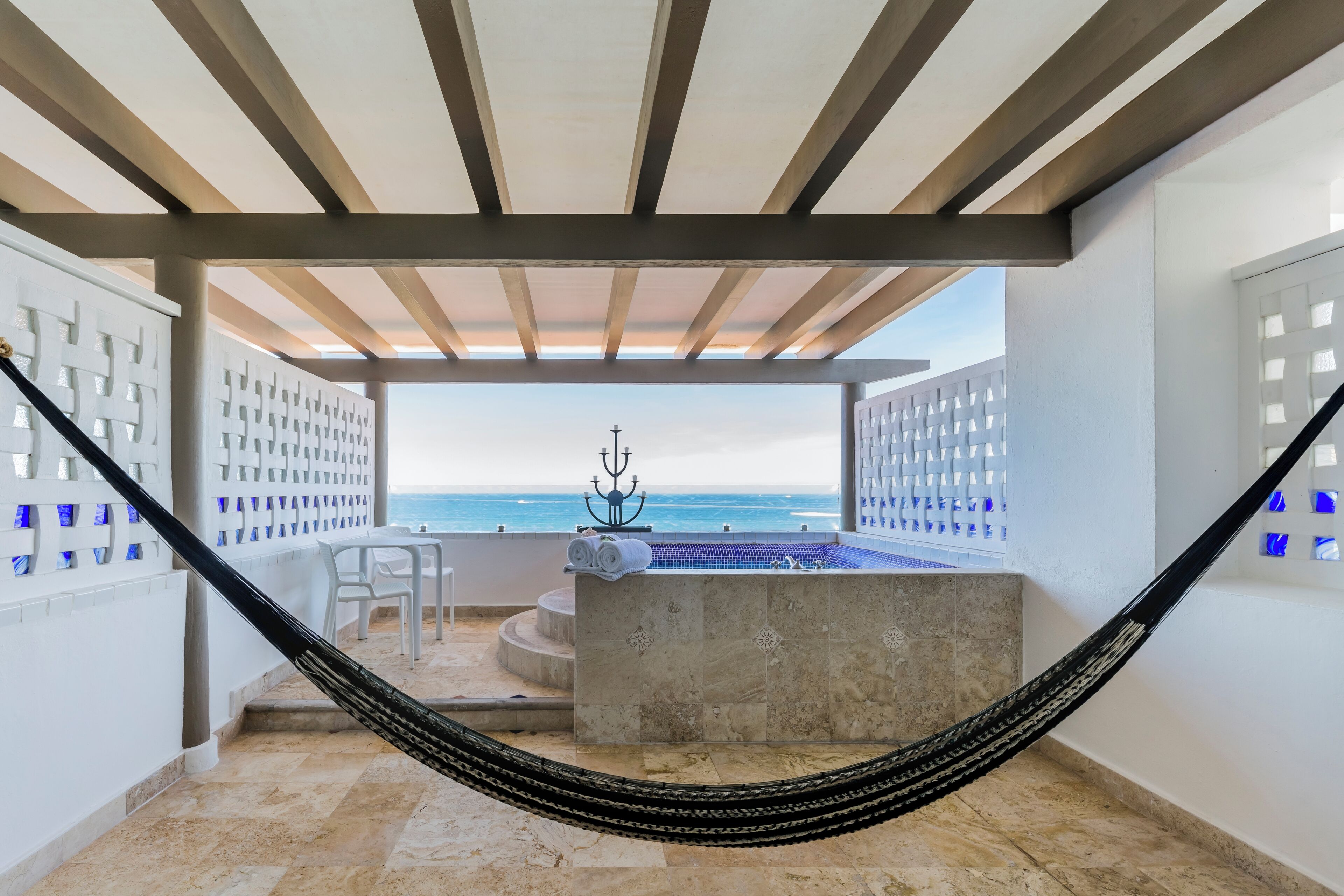 A hammock, a hot tub, and a view of the ocean.