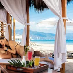 Relax in a serene beachside gazebo with ocean views and a tranquil atmosphere.