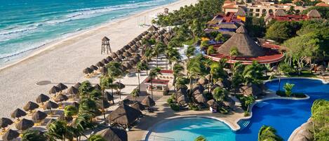 On the beach, white sand, sun loungers, beach umbrellas