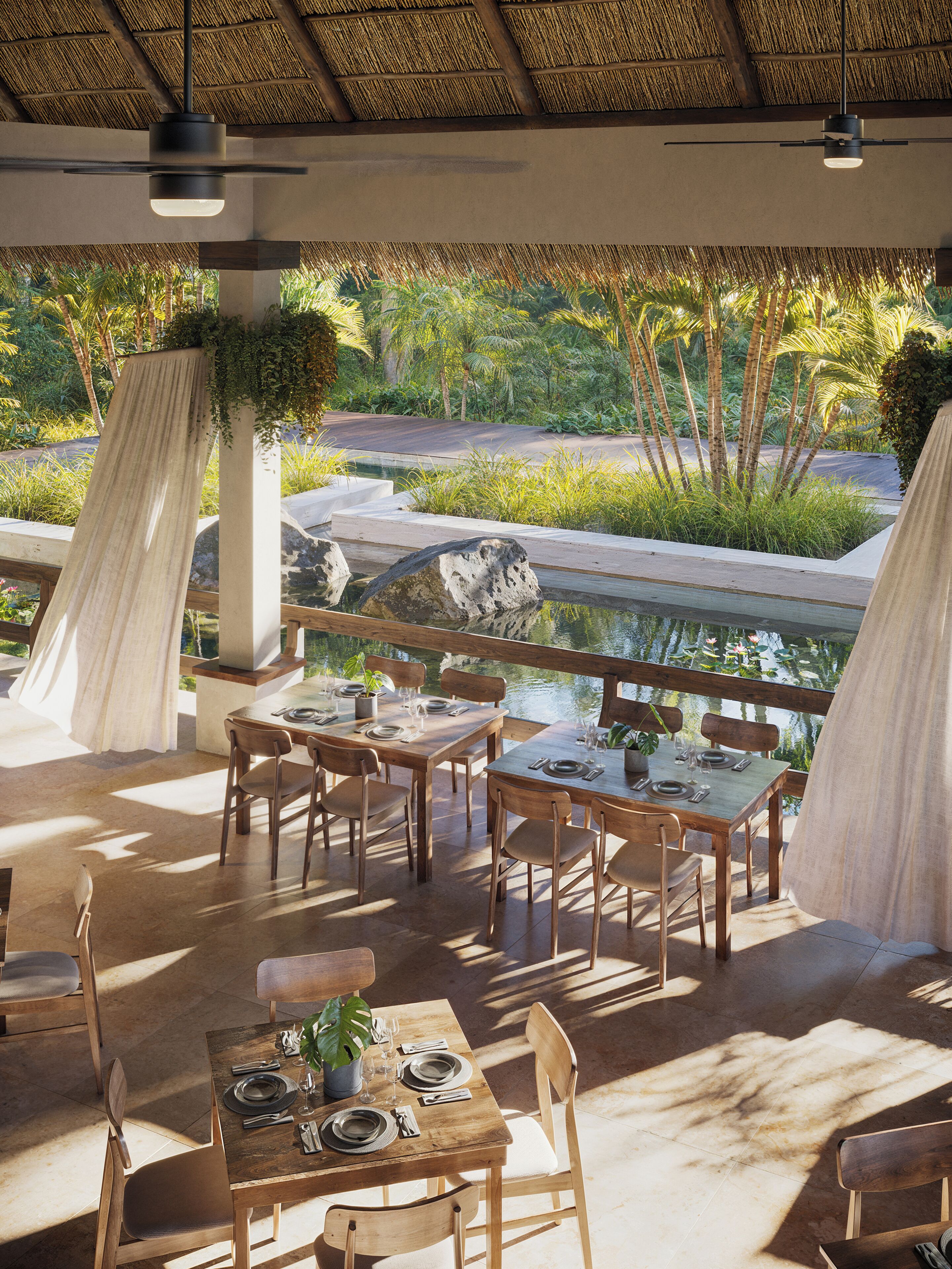 An outdoor dining area with tables and chairs, a thatched roof, and a view of a water feature and greenery.