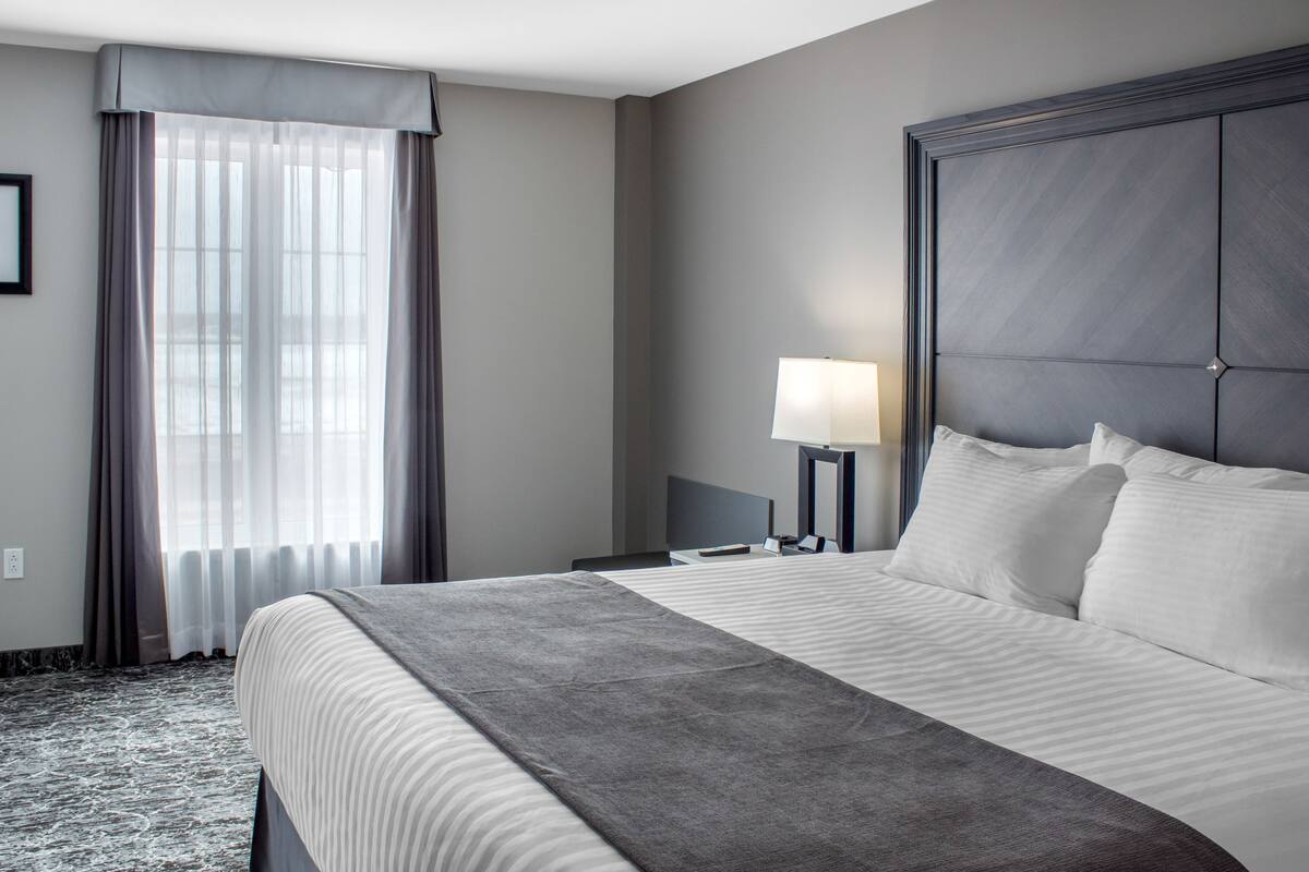 suite, 1 king bed, non smoking, river view (monarch) | desk, laptop workspace, blackout curtains, iron/ironing board