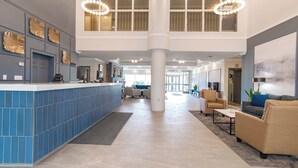 A spacious lobby with a reception desk, seating area, and large windows. - Sandman Hotel Quesnel (Quesnel)