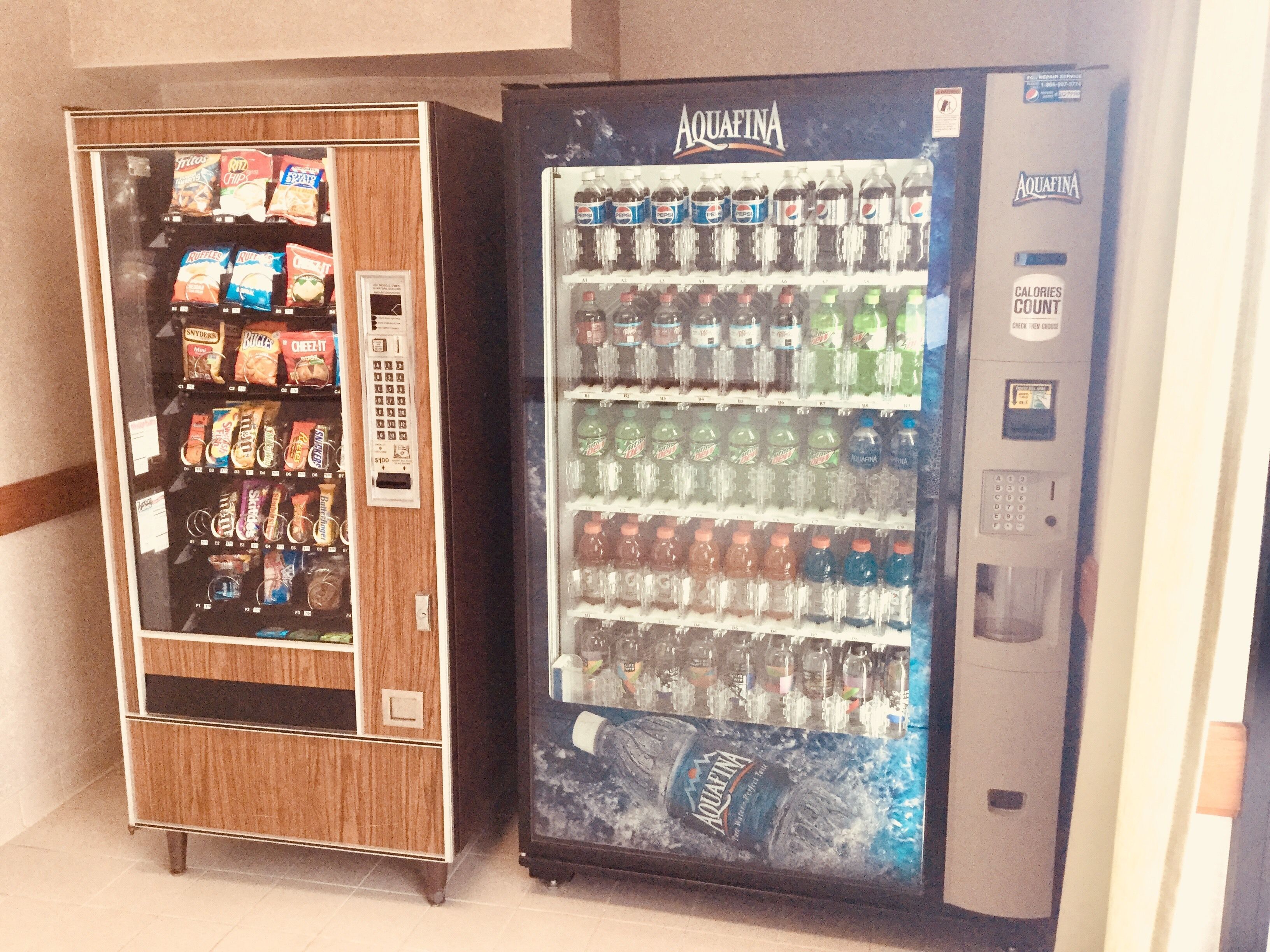 Two vending machines, one with snacks and the other with beverages.
