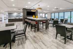 Relax in our spacious lobby, featuring a central bar island and comfortable seating areas.