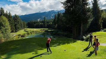 Enjoy a serene golf course setting with breathtaking views of the surrounding mountains and lush greenery.