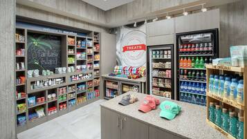 A store with shelves stocked with snacks, drinks, and personal care items.