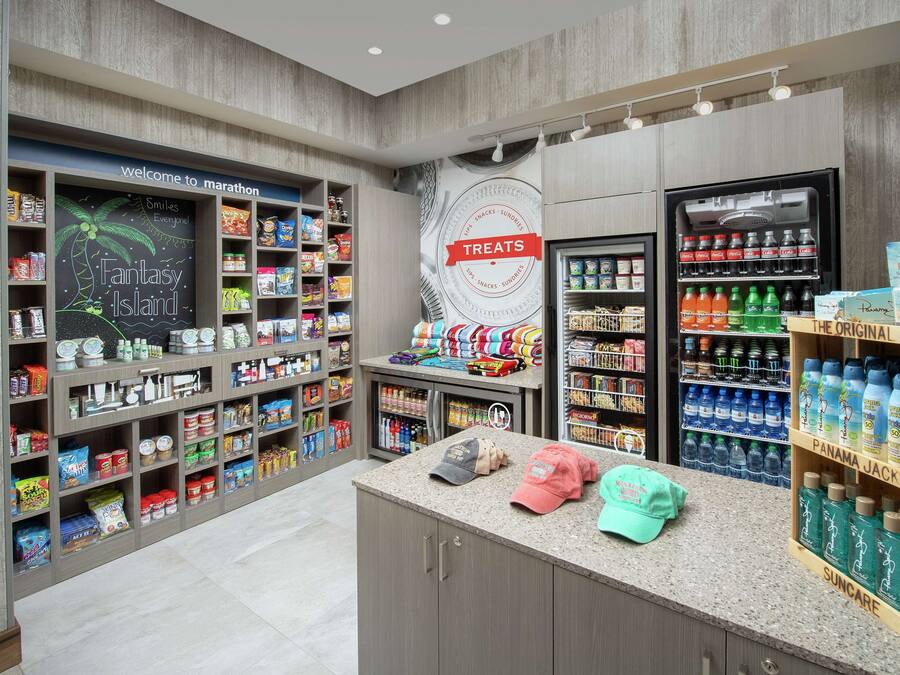 A store with shelves stocked with snacks, drinks, and personal care items.