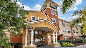 A hotel entrance with a 'Lobby' sign, a 'Stay' America logo, and the year '1951' on the building facade.