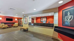 A reception area with a counter, seating, and a television.
