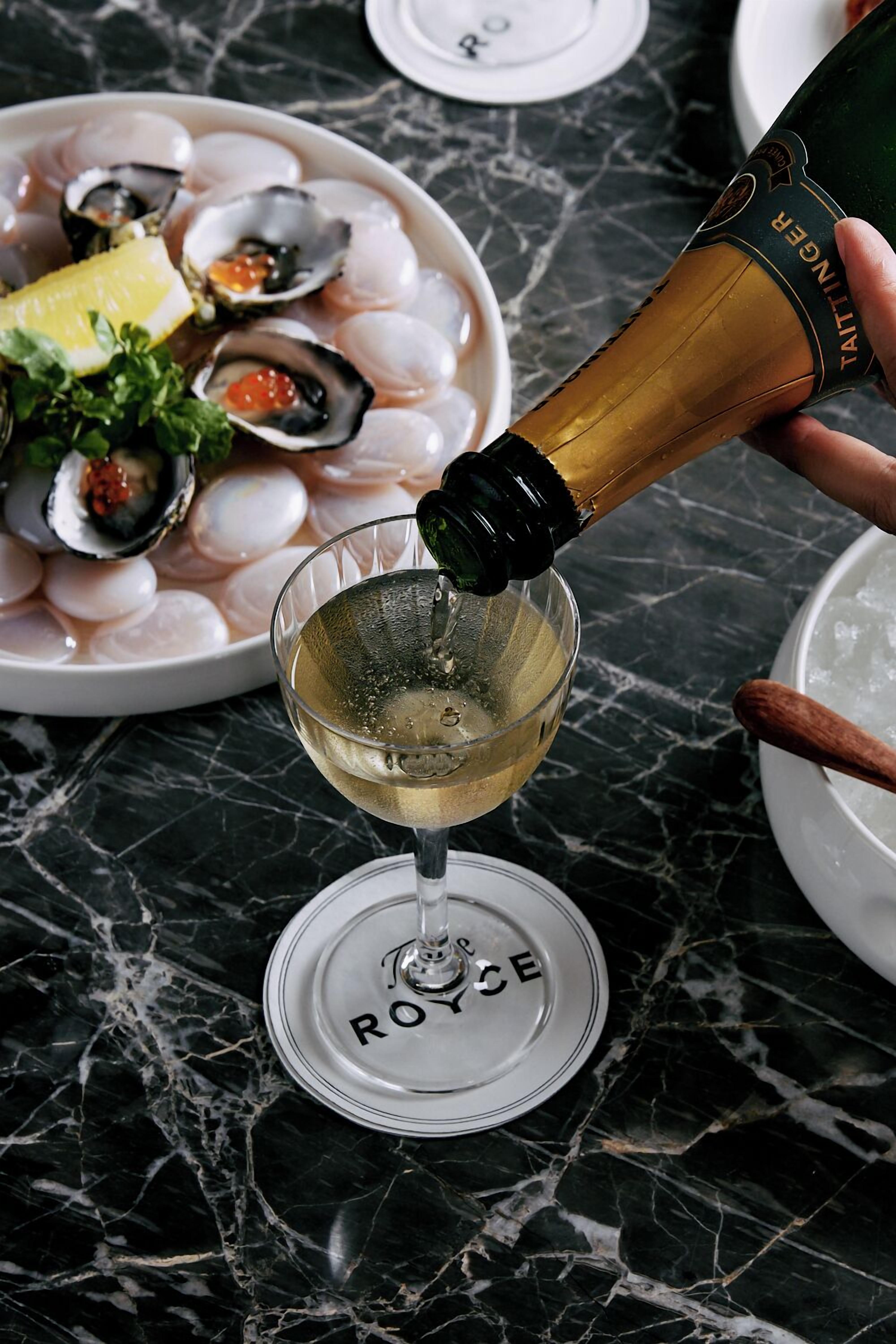 A bottle of champagne being poured into a glass.
