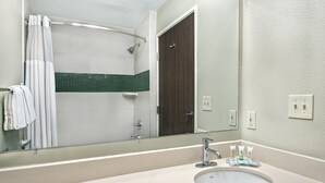 A bathroom with a sink, mirror, shower, and towel rack. - Staybridge Suites Lubbock - University Area by IHG (Lubbock)