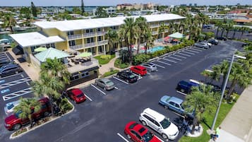 Ein Hotel mit Parkplatz, Poolbereich und Blick auf die Stadt.