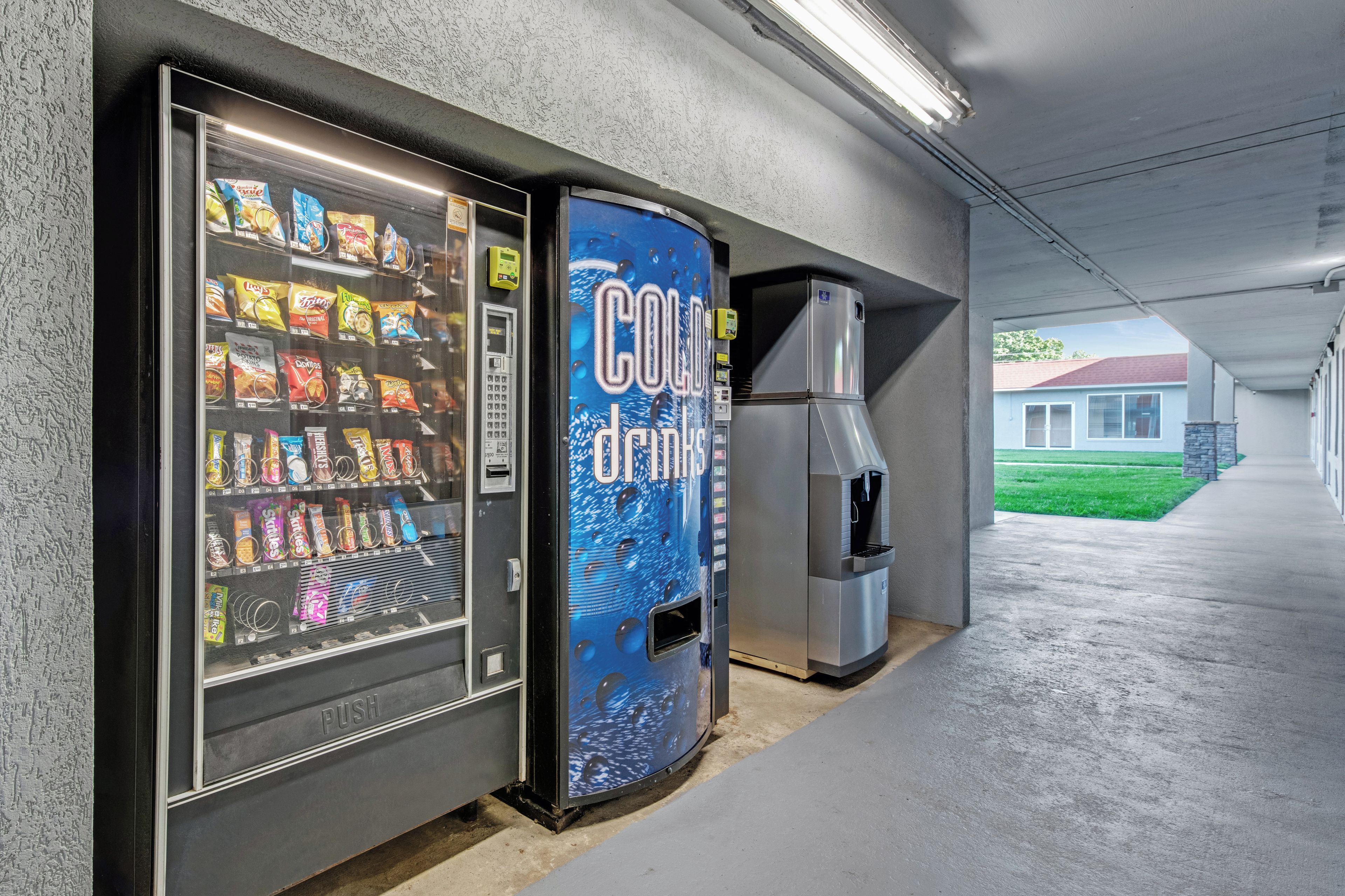 A vending machine with a variety of snacks and a Coca-Cola dispenser.