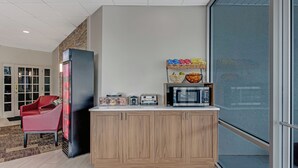 A modern kitchen with wooden cabinets, a refrigerator, a microwave, and a toaster. - Red Roof Inn & Suites Wilkesboro (Wilkesboro)