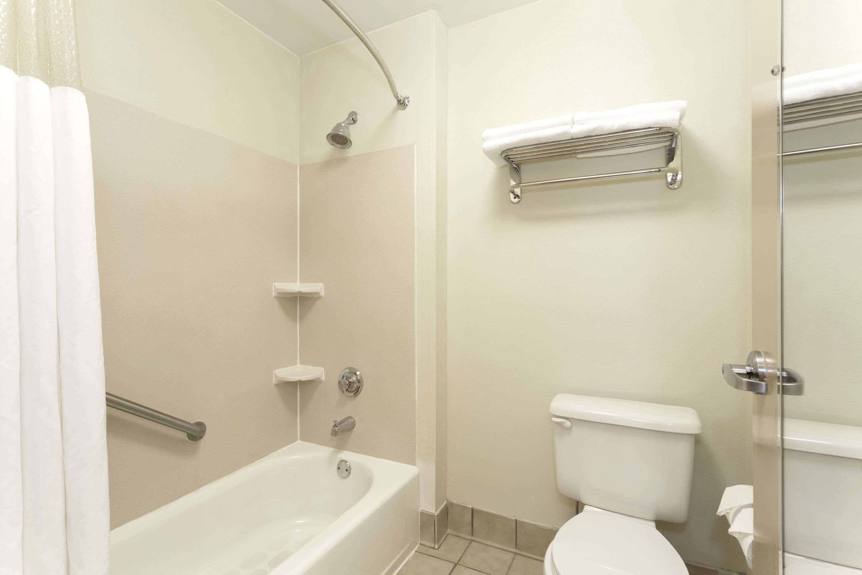 A bathroom with a bathtub, toilet, and shower.