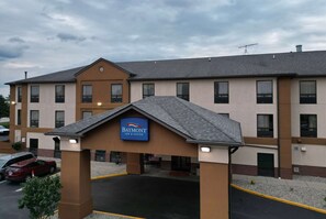 Welcome to Baymont Inn & Suites, featuring a modern entrance with a flat roof and symmetrical facade.