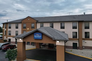 Welcome to Baymont Inn & Suites, featuring a modern entrance with a flat roof and symmetrical facade.
