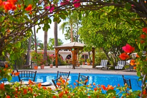 A pool area with lounge chairs and a gazebo. - Hotel del Rio (Navojoa)