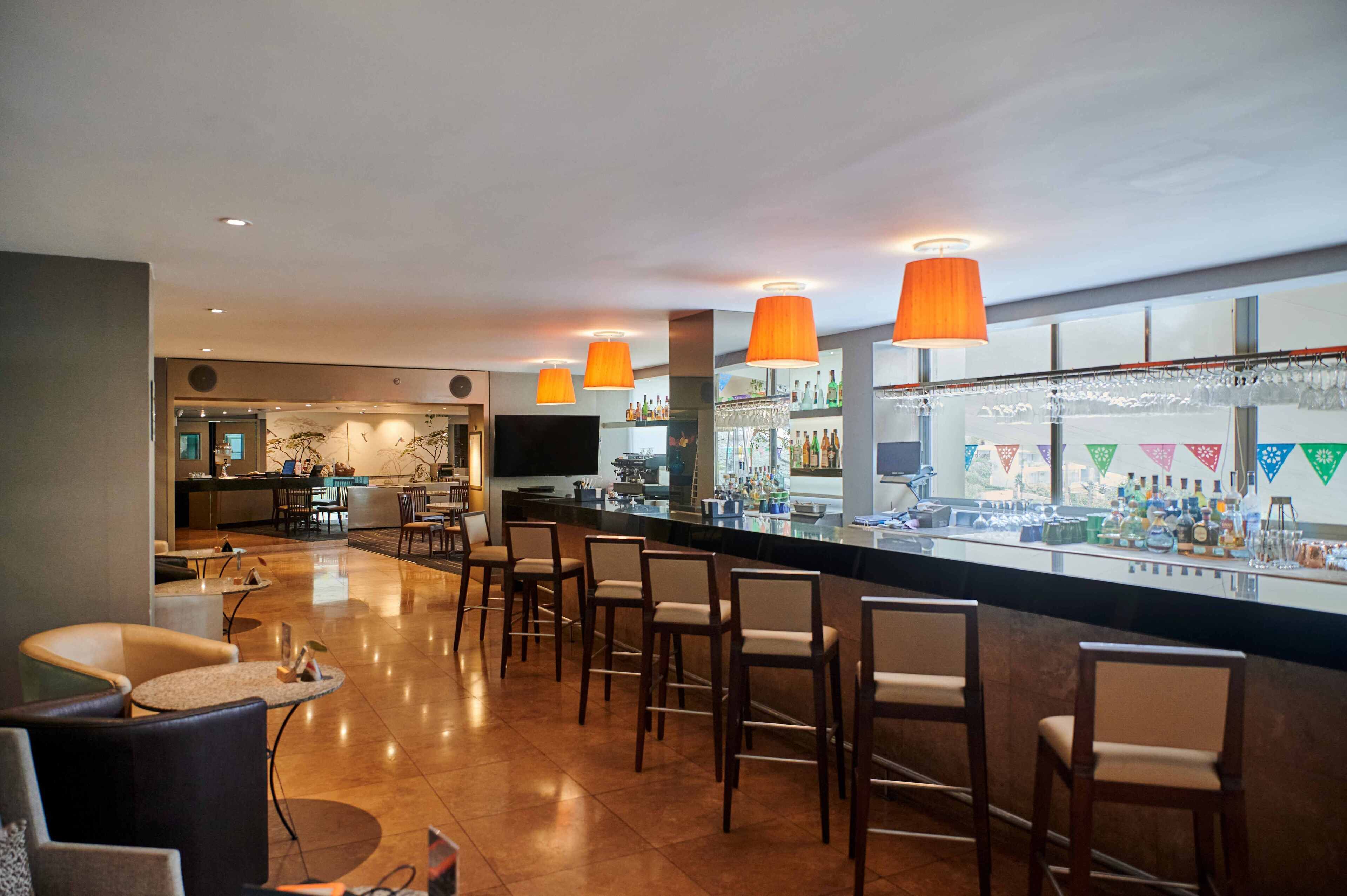 A bar area with seating and a television.