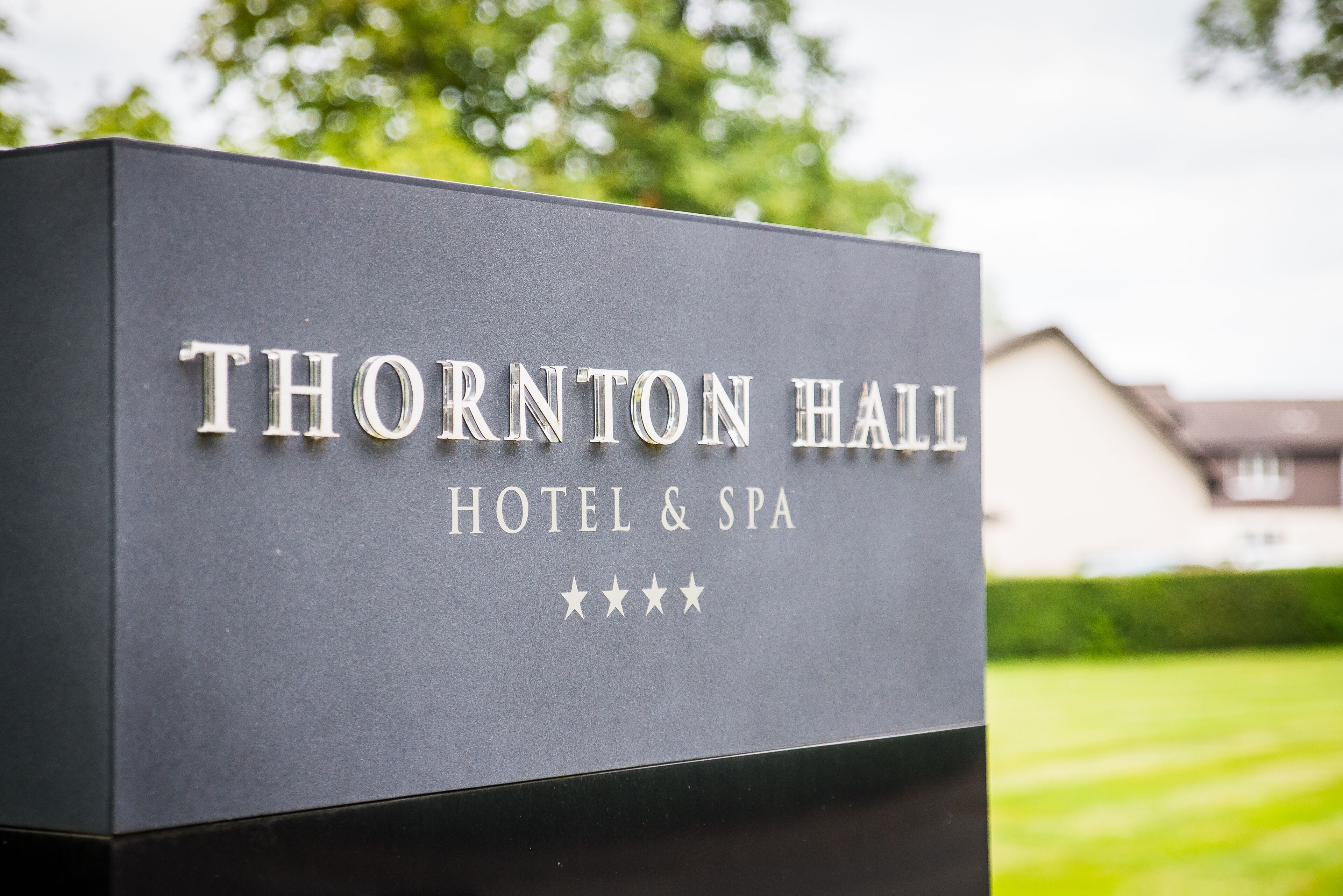 A sign for Thornton Hall Hotel & Spa with a four-star rating.