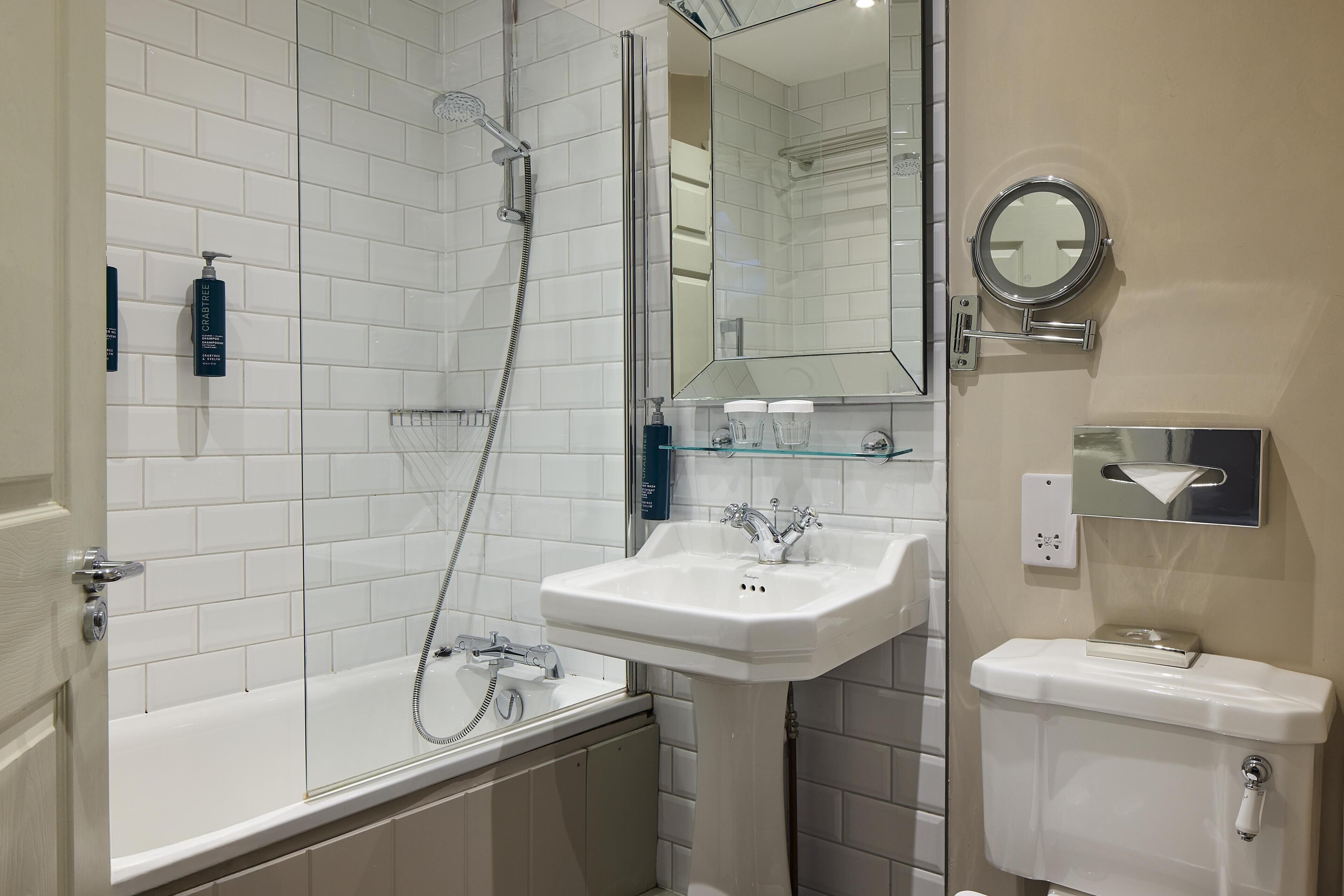 A modern bathroom with a bathtub, a sink, and a toilet.
