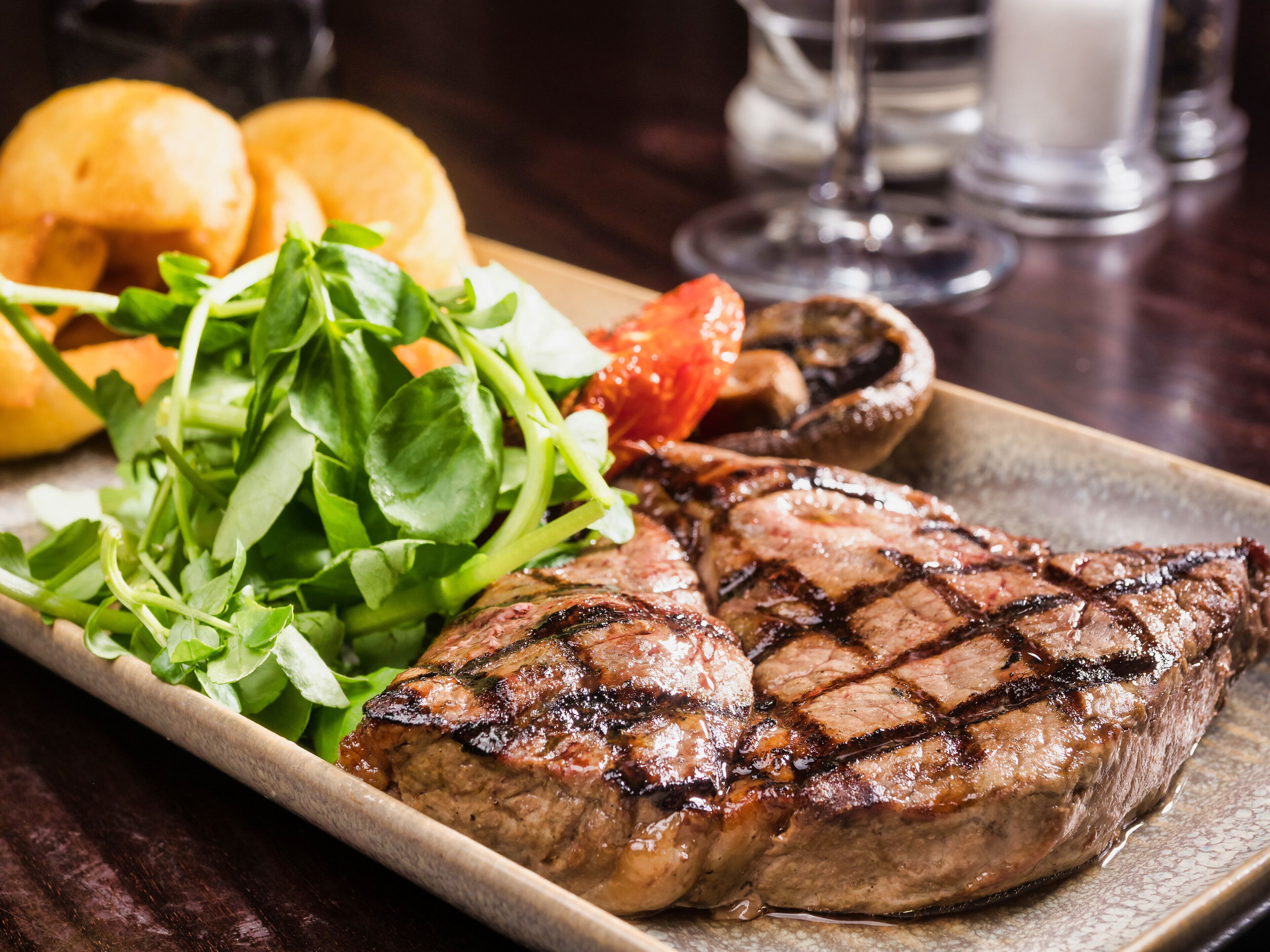 A plate with grilled steak, roasted potatoes, and a side salad.