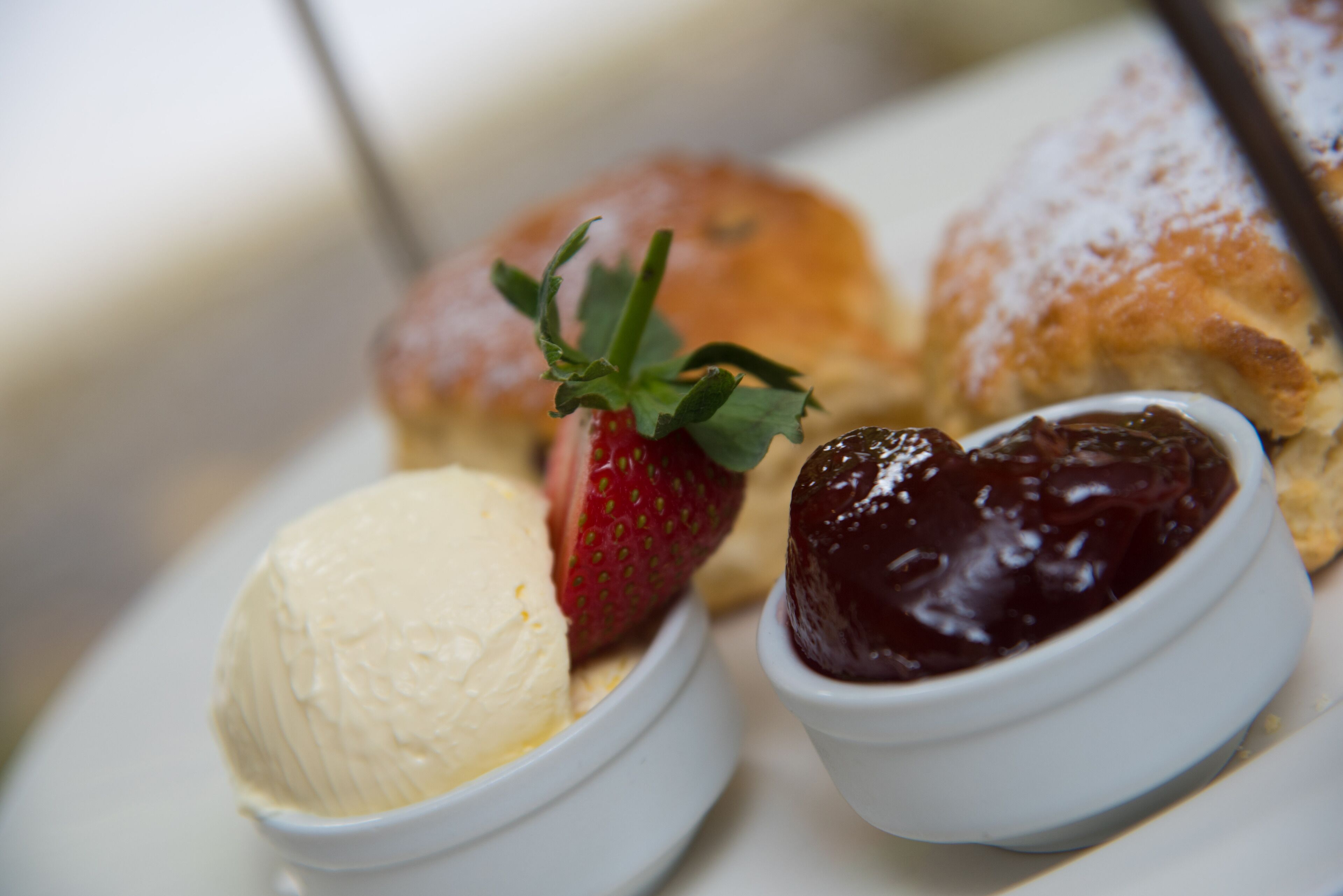 A dessert plate with ice cream, strawberries, and pastries.
