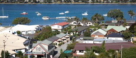A coastal town with a marina, houses, and a hotel.