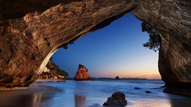 A natural rock formation with a cave-like opening. - Tairua Shores (Tairua)