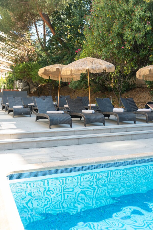 Outdoor pool, open 9:30 AM to 8:30 PM, pool umbrellas, pool loungers