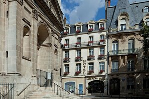 A historic building with a central entrance, multiple balconies with flower boxes, and a sign reading "HOTEL CRYSTAL." - Best Western Plus Crystal, Hotel & Spa (Nancy)