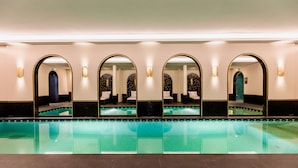 A swimming pool with multiple mirrors and seating areas. - Best Western Plus Crystal, Hotel & Spa (Nancy)