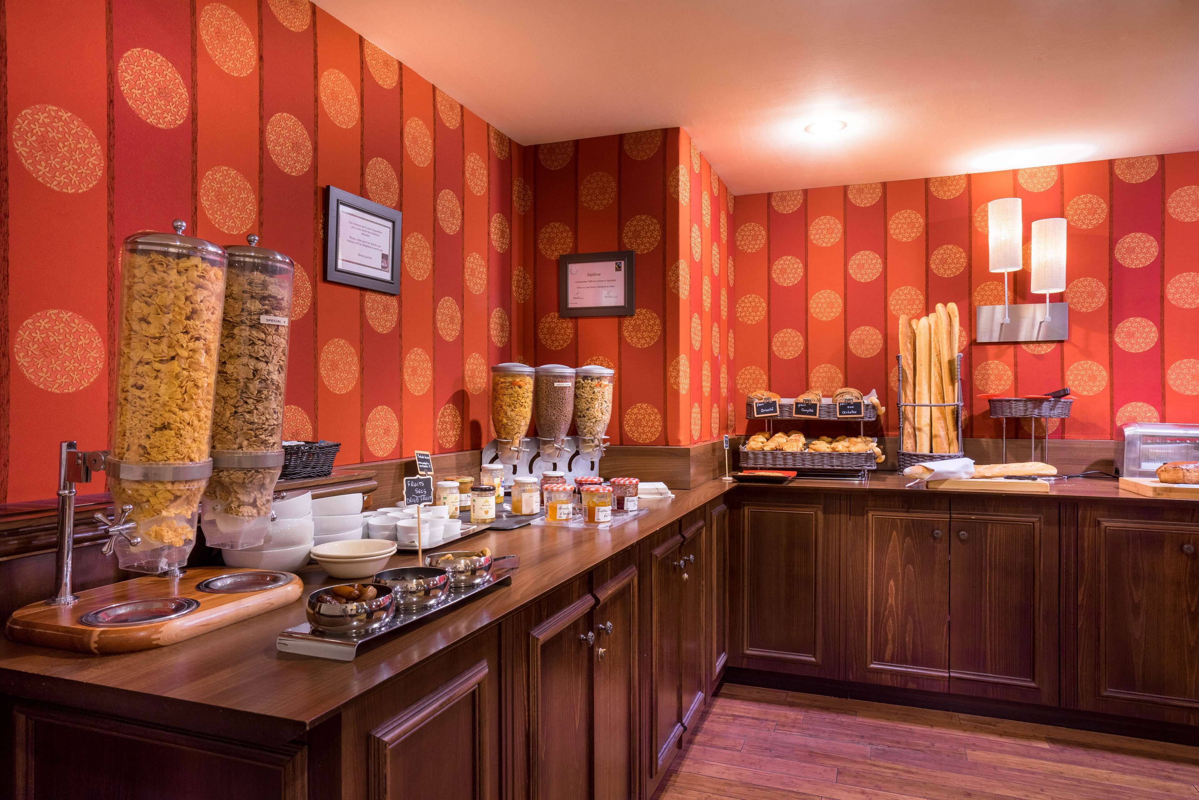 A breakfast bar with various food items and condiments.