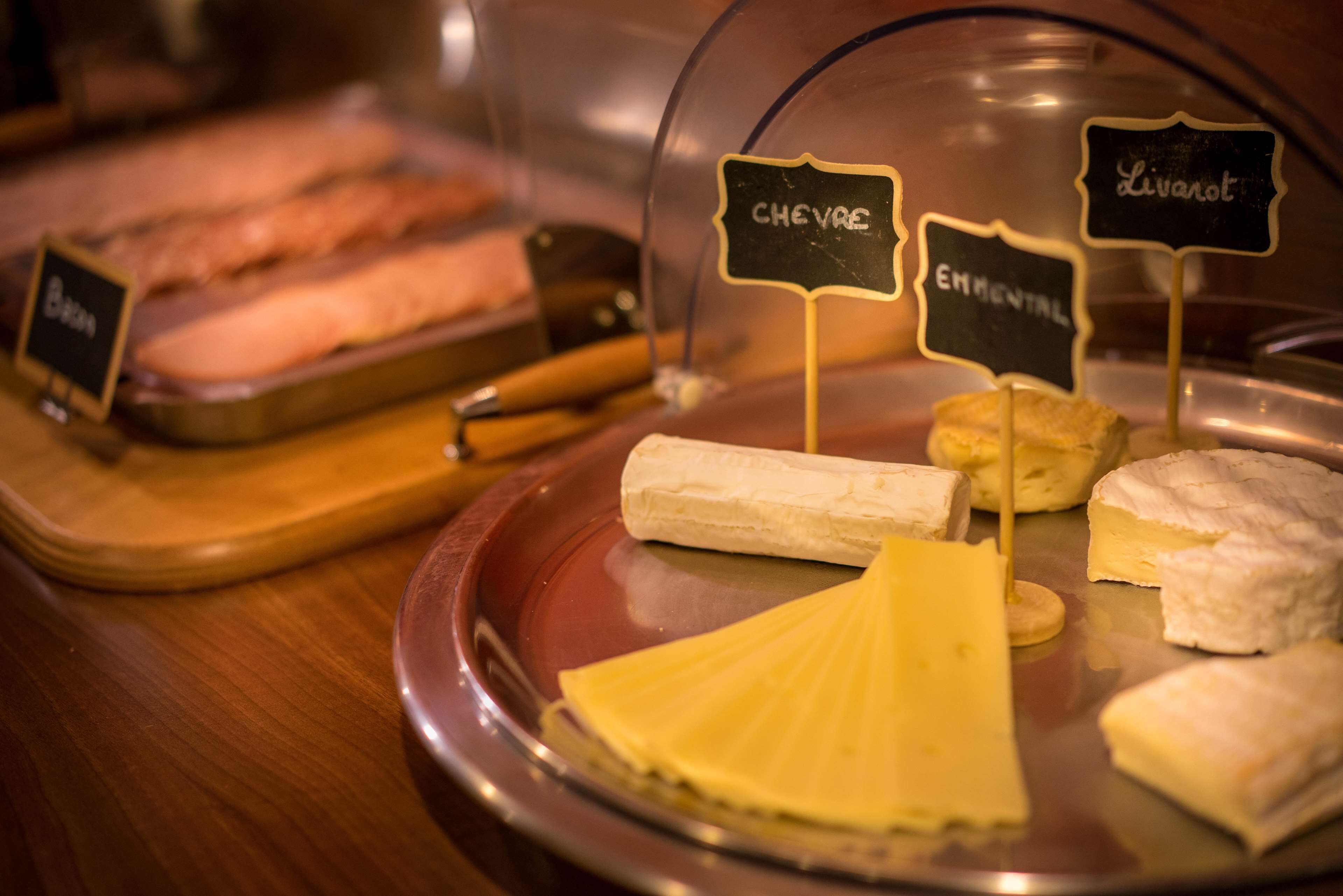 A cheese display with labels for 'Chevre', 'Emmental', and 'Livarot'.