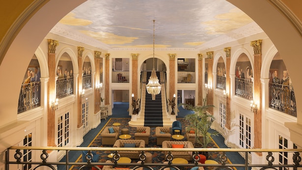 A grand lobby with a central staircase, ornate columns, and a chandelier. - Oceania L'Univers Tours (Tours)
