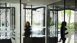 A modern building entrance with decorative metal gates and glass doors. - Oceania L'Univers Tours (Tours)