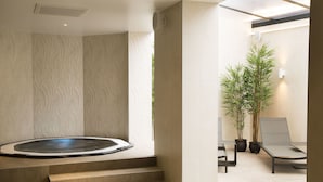 A spa area with a hot tub, steps leading to it, and a seating area with chairs and potted plants. - Oceania L'Univers Tours (Tours)
