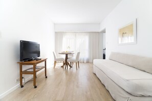 Apartment, 1 Bedroom | Living area | 32-inch LCD TV with cable channels, TV, pay movies