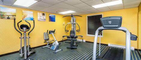 A fitness center with treadmills, elliptical machines, and weight machines.