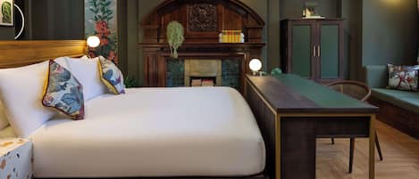 A neatly arranged bedroom with a bed, a desk, and a bookshelf.