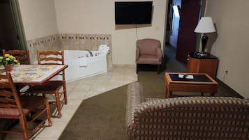 Suite, Jacuzzi, 1 Queen Bed, Kitchen, Non-Smoking | Living area | 32-inch TV with cable channels