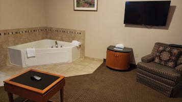 Suite, 1 King Bed with Sofa bed, Non Smoking, Jetted Tub | Living area | 32-inch TV with cable channels